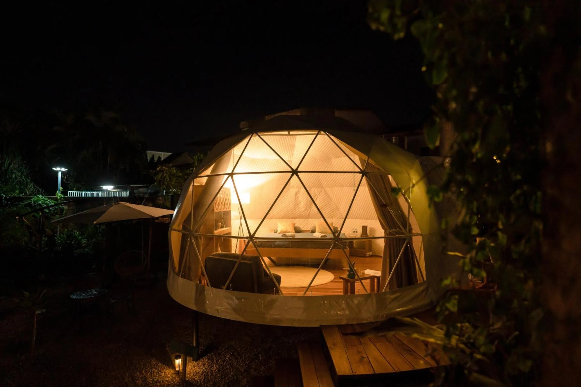 A warmly lit Domea dome at night